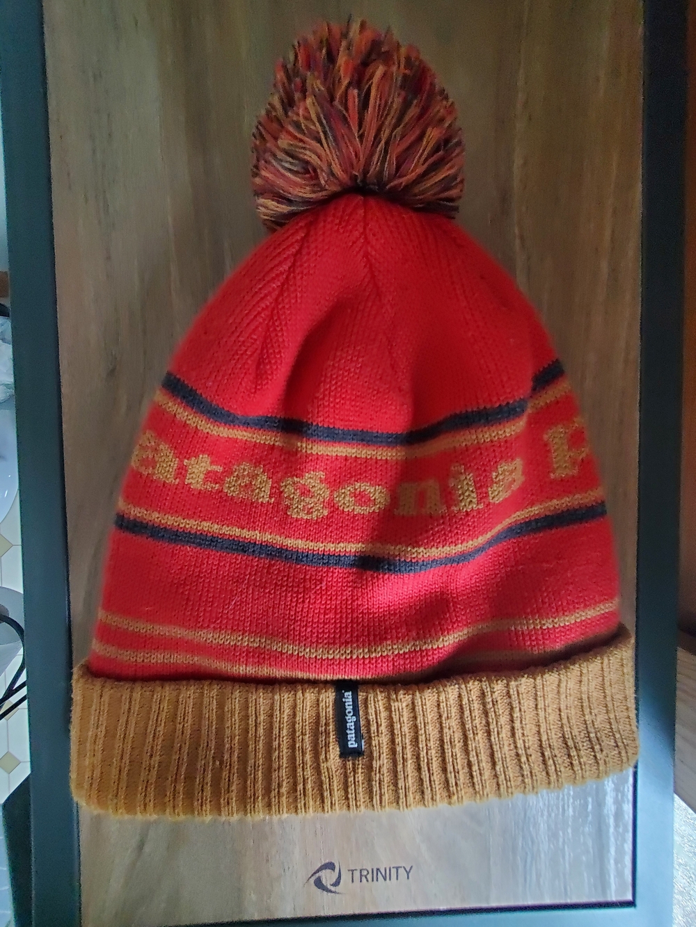 Patagonia Burnt Orange Beanie with Mustard Cuff and Multicolor Pom